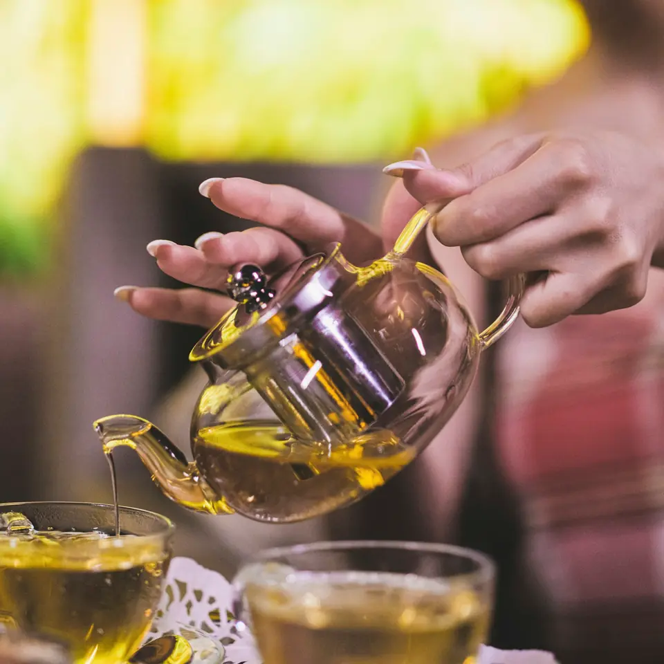 Tea poured from a glass teapot