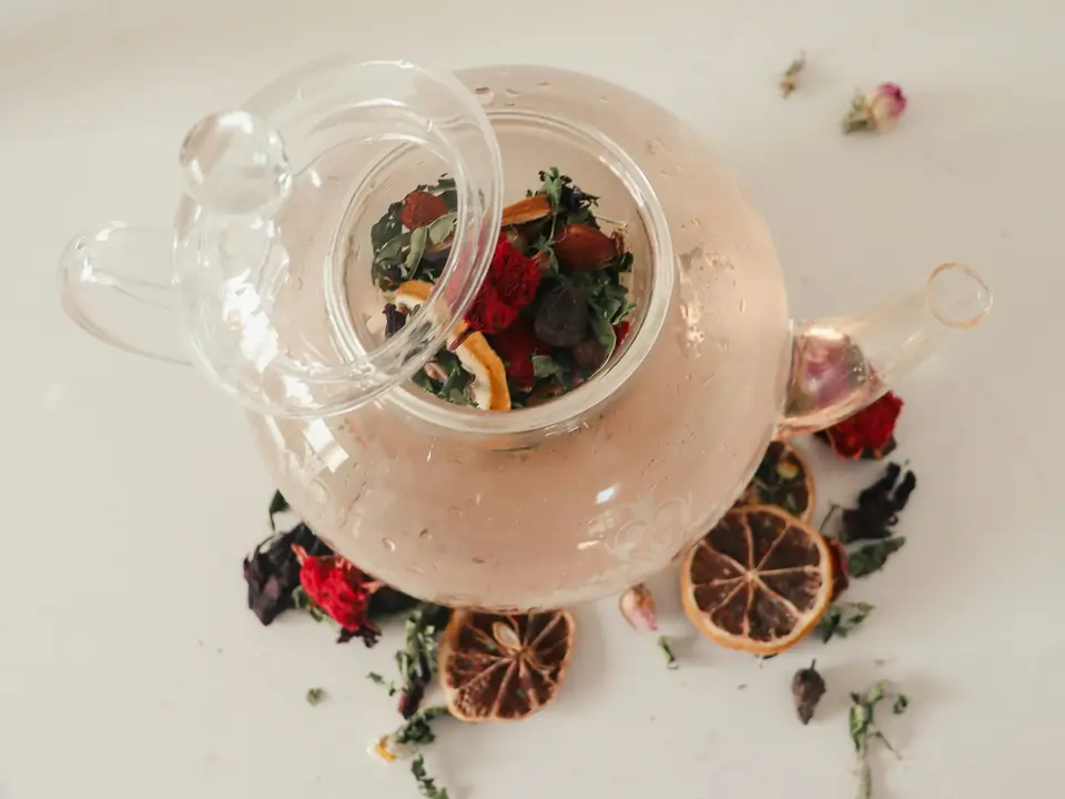 Dried flowers and fruit in a glass teapot